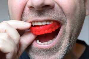 man wearing a red mouthguard